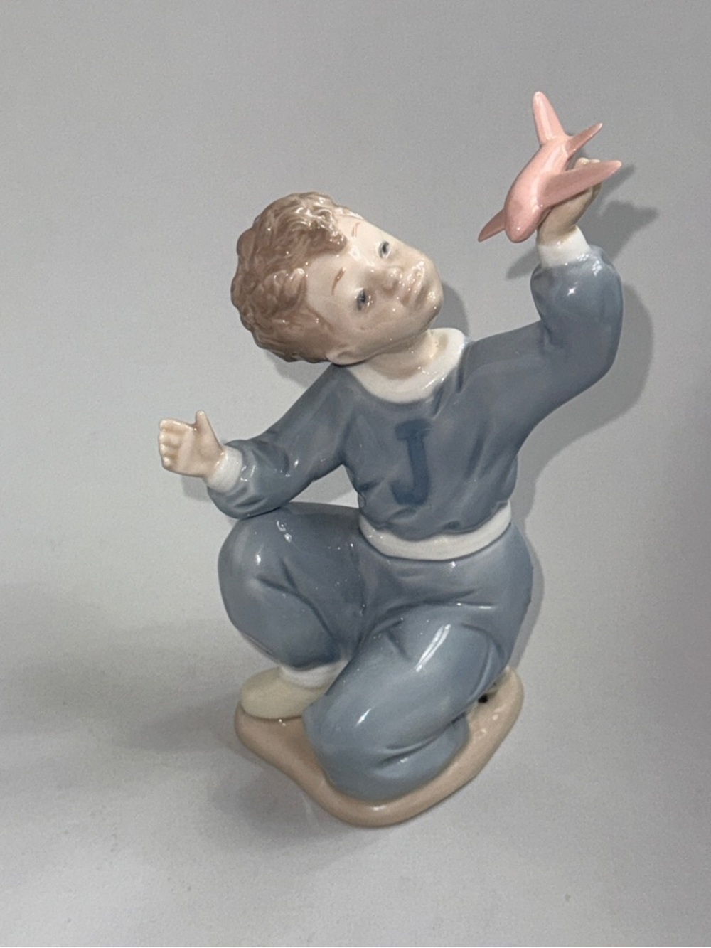 Porcelain Boy Figurine with Pink Airplane Lladro Nao Spain 1133